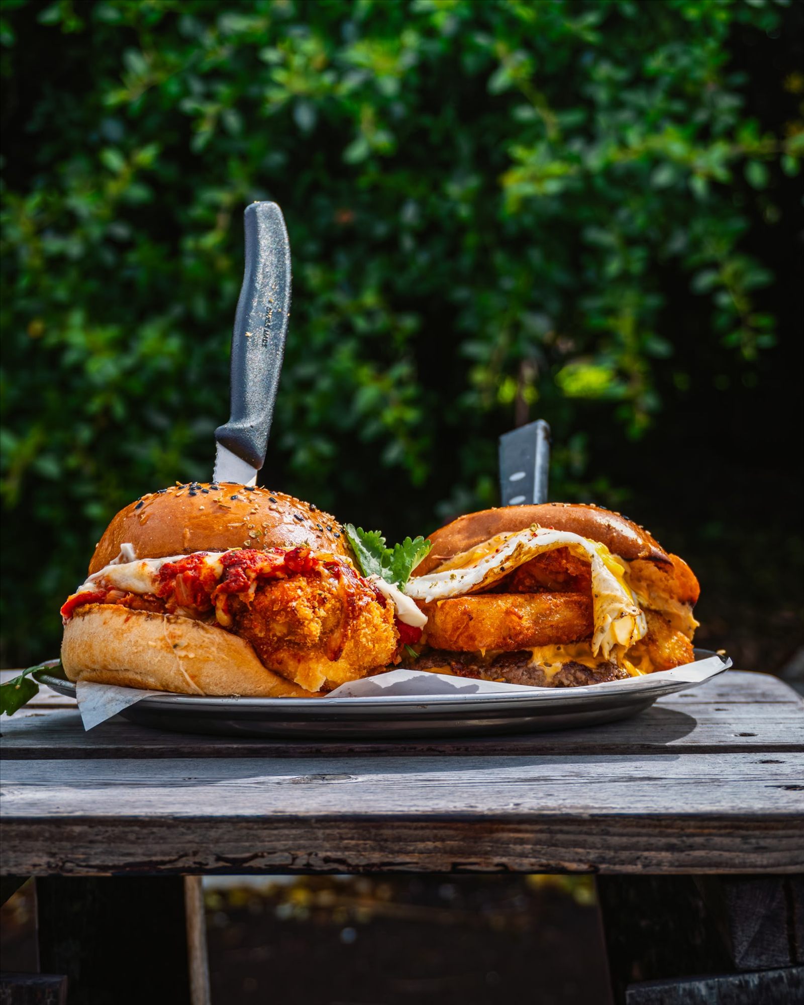 Two Grime burgers on a metal tray outdoors