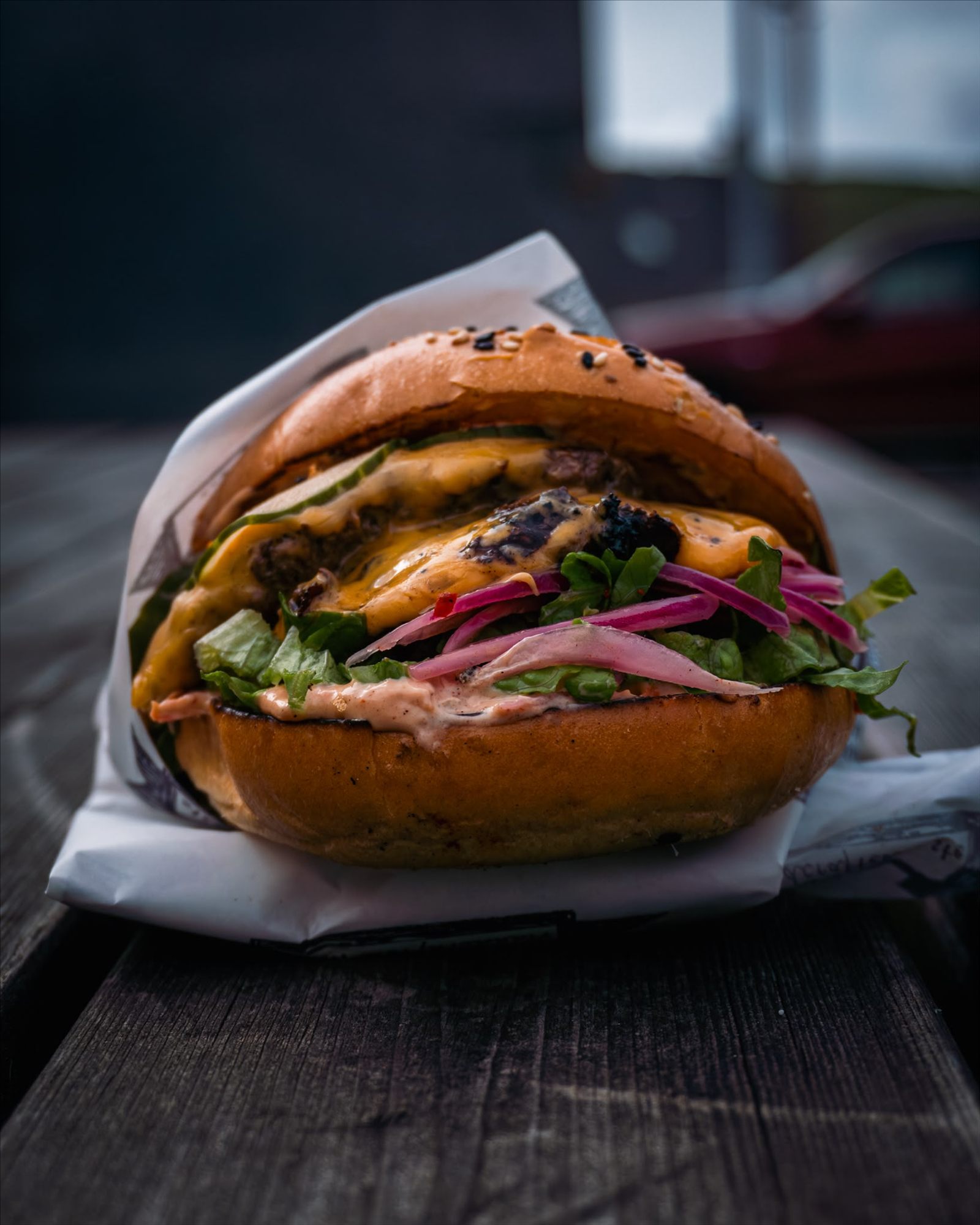 Grime smash burger with melted cheese, lettuce and pickled red onion